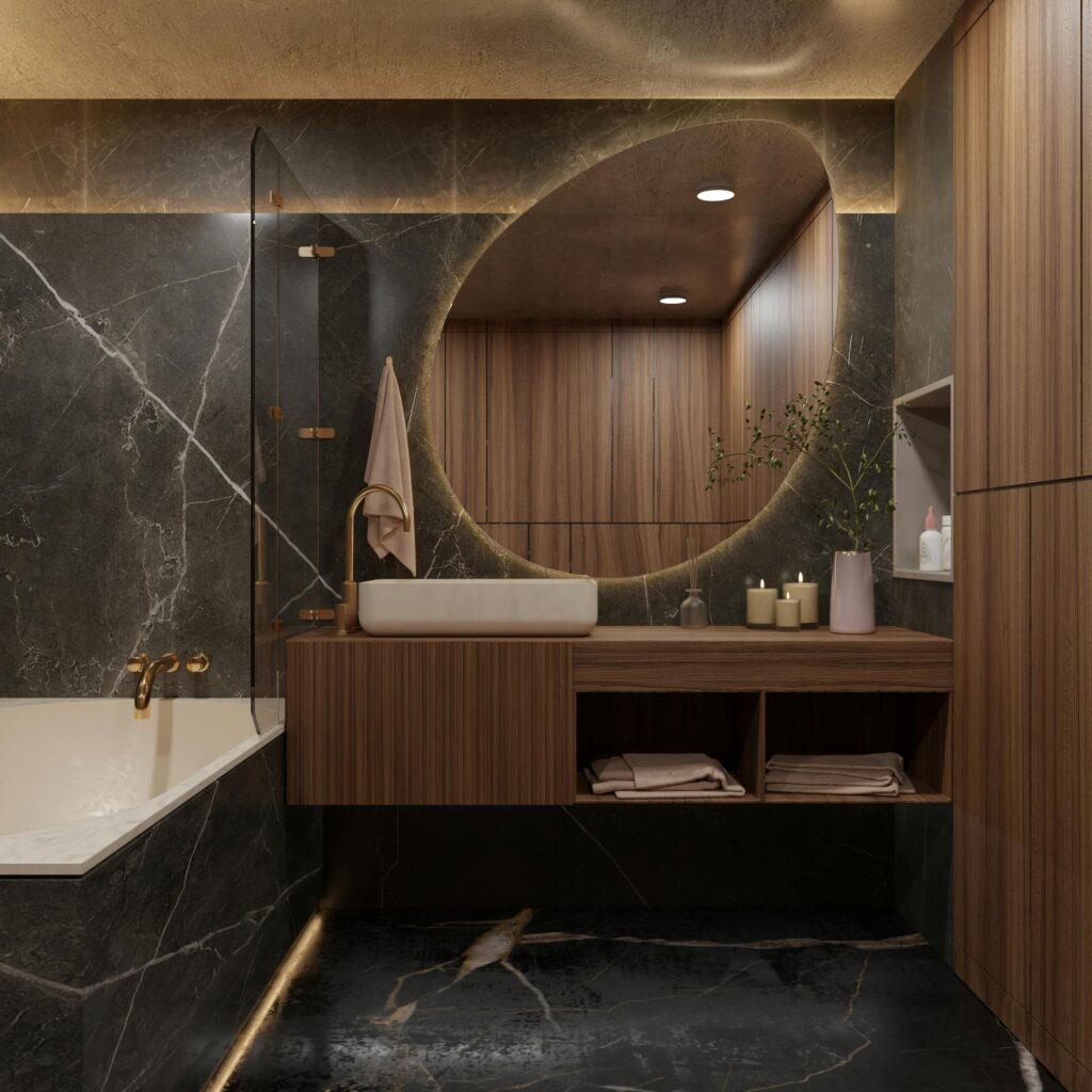 High-end bathroom featuring marble finishes, round mirror, and wooden accents, exuding luxury.
